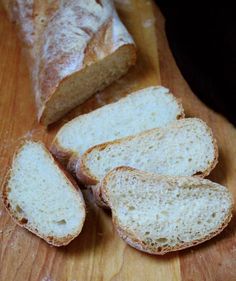 sliced bread sitting on top of a wooden cutting board