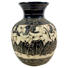 a black and white vase with an elephant design on the front, sitting against a white background