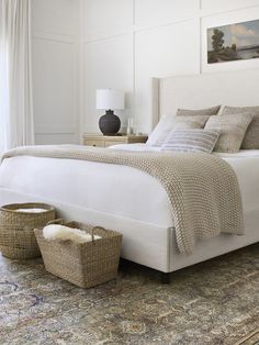 a white bed sitting in a bedroom on top of a rug