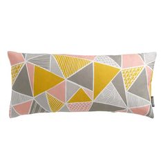 a grey and yellow pillow with geometric shapes on the front, along with a light pink background