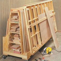 a wooden shelf with several pieces of wood stacked on top of it and tools next to it