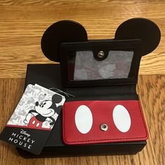 the mickey mouse wallet is open and ready for someone to put it in its case