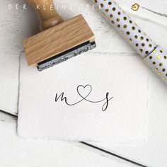 a rubber stamp with the word n and s on it next to a polka dot wrapping paper