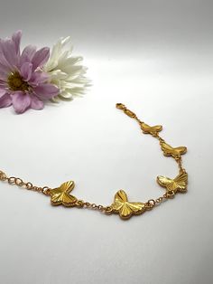 This stunning stainless steel gold butterfly bracelet is a masterpiece of elegance and sophistication. Adjustable to fit any wrist, its high-quality construction ensures a comfortable and durable wear. The delicate butterfly design adds a touch of whimsy and romance, making it a perfect accessory for any occasion. Gold Butterfly-shaped Metal Jewelry, Gold Butterfly Metal Jewelry, Adjustable Gold Butterfly Jewelry, Adjustable Butterfly Gold Jewelry, Gold Metal Jewelry With Butterfly Clasp, Gold Metal Jewelry With Butterfly Charm, Adjustable Gold Bracelets With Butterfly Clasp, Elegant Gold Bracelets With Butterfly Clasp, Elegant Gold Bracelet With Butterfly Clasp