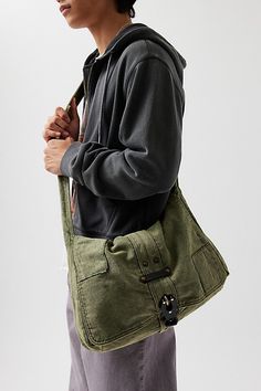 Classic look messenger bag with a flap top closure. Washed cotton bag with a secure latch closure front and rivet accents at the shoulder strap. Features Patched messenger bag Washed cotton bag Flap front Secure buckle down closure Shoulder strap Content + Care 100% Cotton Spot clean Imported | Patched Messenger Bag in Olive, Men's at Urban Outfitters Messenger Bags For School, Mens Satchel, Men's Shoes Accessories, Bdg Jeans, Women Men Shoes, Small Crossbody Bag, Jeans For Sale, Cotton Bag, Classic Looks