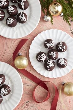 three plates with chocolates on them next to christmas decorations