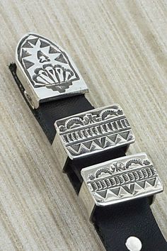 This sterling silver Ranger belt buckle was made by Navajo silversmith Leonard Maloney. The back of the buckle is signed and stamped sterling.Buckle:Length: 2 5/8"Width: 2"Keepers:Length: 1"Width: 5/8"Height: 5/8"Tip:Length: 1 1/4"Width: 3/4"Height: 1/4"Free shipping on all orders! We ship with USPS and always include tracking. All orders ship within a day of payment.Returns are accepted up to 30 days after you receive your order. Just send us a message. Our shop offers cash back or store credit Silver Hand Tooled Adjustable Belt Buckles, Rectangular Engraved Silver Belt Buckles, Artisan Adjustable Silver Belt Buckles, Artisan Silver Adjustable Belt Buckles, Adjustable Silver Southwestern Belt, Adjustable Southwestern Silver Belt, Adjustable Silver Southwestern Belt Buckles, Ranger Belt, Adjustable Silver Hand-tooled Belt Buckles