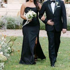 a man and woman in formal wear walking together