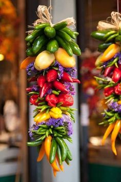 several hanging baskets filled with different types of vegetables