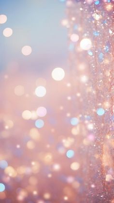 blurry image of beads hanging from the ceiling in front of a blue and pink background