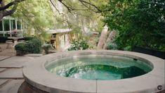 an outdoor hot tub surrounded by stone steps