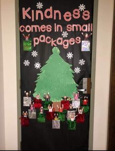 a door decorated with christmas decorations and writing that says, kindness comes in small packages