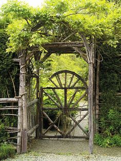 an old wooden gate surrounded by greenery