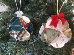 two ornaments are hanging from a christmas tree