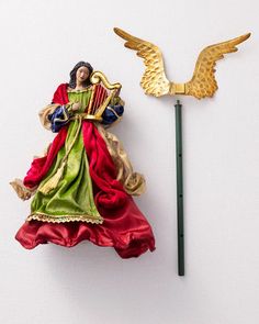 an angel figurine next to a wand