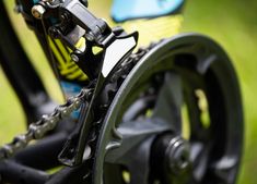 the rear end of a bike with gears and chain