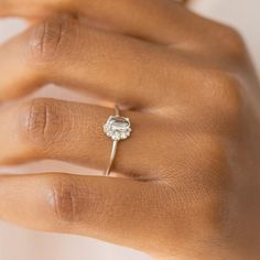 a woman's hand with a diamond ring on it