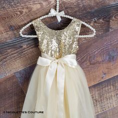 This dress is just beautiful! It is a beautiful shade of ivory/cream tulle on the bottom. The gold sequin top add a fun, elegant feel while the full tulle bottom is a little girl's dream! It also has an embellished ribbon bow sash that is removable. Super comfortable and perfect for your next special event. IDEAL WEAR: Flower Girl Dress Cake Smash First Communion Photography Prop Bridesmaid dress Paired with Cowboy boots Baptism Tea Party Birthday Rustic theme Wedding First Birthday size, Bust, Cream Flower Girl Dress, Sequin Flower Girl Dress, Flower Girl Dresses Champagne, Dubuque Iowa, Gold Sequin Top, Sequin Flower, Bow Sash, Tulle Wedding Gown, Heirloom Dresses