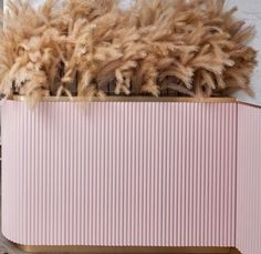 a pink cabinet with lots of fur on top