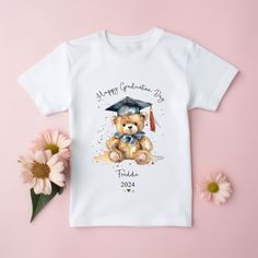 Personalised School Graduation T-Shirt Add the name of child and the Year Handprinted to order . BREATHABLE WICKING FABRIC - 65% polyester 35% cotton. Ideal for the summer. . QUICK DRYING - Fabric does not hold on to water like a cotton shirt would, and is fast to dry out of the wash ready for your next gym session. No need to iron! . Polyester . Machine Wash . Fastening: Pull On . Collar Style: Round Collar . Fitted . Short Sleeve . (Machine wash at 30). . Flatlock comfort seams to avoid irrita Short Sleeve T-shirt For School Events In Summer, School Spirit T-shirt With Letter Print As Gift, Summer School Events Cotton T-shirt, School Spirit Crew Neck T-shirt With Character Print, School Spirit T-shirt With Character Print, Summer Cotton T-shirt For School Events, Graphic Print T-shirt For End Of School Year Gift, School Spirit Graphic T-shirt As Gift, End Of School Year Graphic Print T-shirt Gift