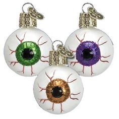 three ornaments with different colored eyes on them