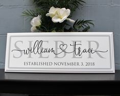 a wooden sign that says sullian and trai established november 3, 2018 on a table