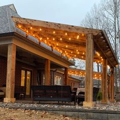 an outdoor covered patio with lights strung over it