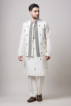 Ivory bundi with Mughal thread embroidery. Paired with an embroidered kurta and pant. - Aza Fashions Designer White Cotton Nehru Jacket, Off White Nehru Jacket With Resham Embroidery, White Cotton Nehru Jacket With Cutdana, Designer Cotton White Nehru Jacket, White Cotton Nehru Jacket For Designer Wear, White Kurta With Embroidered Border For Transitional Season, Transitional White Kurta With Embroidered Border, White Chanderi Bandhgala With Cutdana, White Chanderi Nehru Jacket With Resham Embroidery