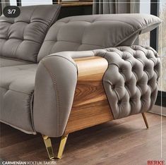 a grey couch sitting on top of a wooden floor