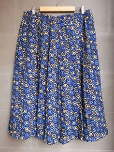 Vintage abstract print pleated skirt from the 1990's. Women's high waist skirt with an abstract print in shades of blue, yellow and olive green. Skirt has an elastic waist. Falls free below the knees. Fully lined. Material: 100% Polyester Size: 48 DE, which is 18 US or XL. To be sure this item would fit you, please look at the measurements below. Approximate Measurements (taken while skirt is lying flat, double waist): Waist (double that): Stretches from 17 inches / 43.1 cm up to 21.7 inches / 3 Retro Pleated Midi Skirt, Retro Summer Pleated Midi Skirt, Retro Pleated Full Skirt Bottoms, Retro Pleated Flared Skirt For Summer, Retro Summer Midi Pleated Skirt, Retro Summer Pleated Skirt, Retro Long Pleated Skirt, Retro Full Pleated Skirt For Summer, Retro Long Skirt With Lining