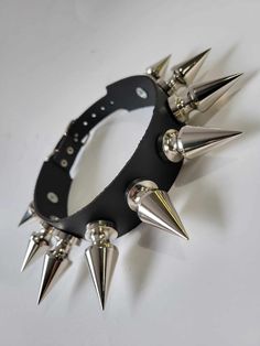 "Leather Choker with 9 chunky tree spikes size 1.80\" x 0.80\".Punk Goth Metal spikes size : 1.80\" high and 0.80\" diameter at the bottom . or 46 mm high and 20 mm wide at the bottom  Quality Leather Choker designed and hand crafted by me in Montreal for you Top quality hardware and Cow split leather that would last a lifetime I make it in size : X small 12\" to 14\" neck,Small 14\" to 16\" neck,Medium 16\" to 18\" neck, Large 18\" to 20\" neck    Please wrap any cord around your neck where the choker rests than measure the cord to get the size of your neck in inches or mm if you another size plz message me" Punk Jewelry With Spikes For Alternative Fashion, Punk Jewelry With Spikes, Gothic Jewelry With Spikes For Alternative Fashion, Punk Spiked Jewelry For Concerts, Punk Jewelry With Spikes For Concerts, Black Punk Jewelry With Spikes, Edgy Spiked Jewelry For Concerts, Gothic Spiked Jewelry For Halloween, Gothic Halloween Jewelry With Spikes