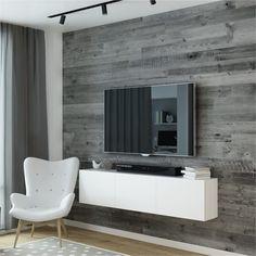 a living room with a white chair and a television on a stand in front of a wooden wall