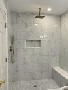 a walk in shower sitting next to a white sink under a faucet mounted on a wall