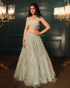 This sea green lehenga features hand embroidered 3D flowers throughout along with sequin,crystal, pearl and cutdana embroidery. It is paired with a matching V neck blouse with tassel and shoulder cap detailing, including an embroidered dupatta.From Isa by Dolly Wahal's Fiori collection.DELIVERY TIMEPlease allow 8-12 weeks for your outfit to arrive.FABRIC DETAILSNetProfessional cleaning only. Sea Green Lehenga, Cutdana Embroidery, Floral Lehenga, Green Lehenga, Embroidered Dupatta, 3d Flowers, 12 Weeks, V Neck Blouse, Sea Green