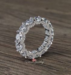 a diamond ring on top of a wooden table