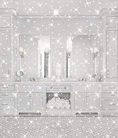 a white bathroom with stars on the wall