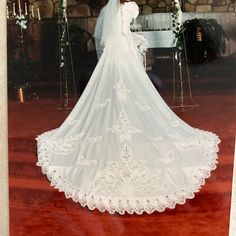 an old photo of a bride in her wedding dress standing at the alter with flowers