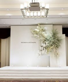 a large floral arrangement on display in front of a white backdrop