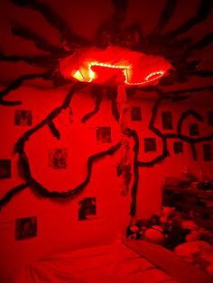 a room with red light and pictures on the wall