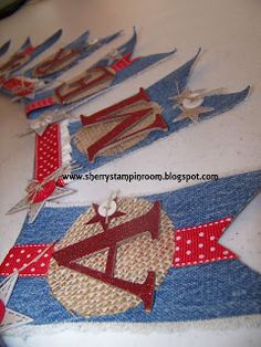 some red white and blue flags are on a table with pins in them that have been sewn together