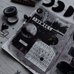 an open book with various items on top of it and the words moon written in black