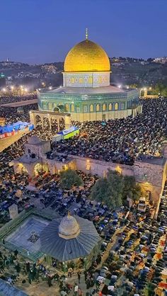 an aerial view of the dome of the rock in the middle of the city at night