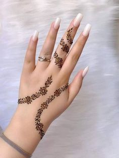 a woman's hand with hennap on it and two rings in the middle