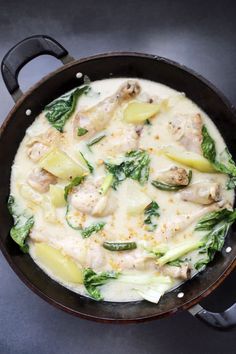 a skillet filled with chicken and vegetables