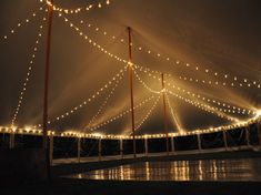 a large tent with lights hanging from it's sides