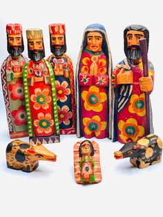 several colorfully painted wooden figurines sitting next to each other