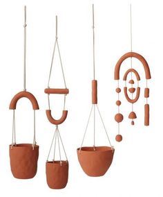 three hanging planters made out of clay and wood, each with different shapes and sizes