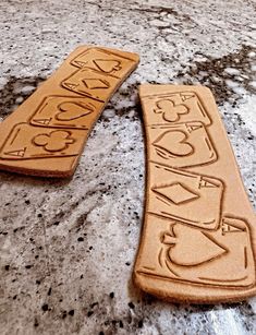 two wooden signs sitting on top of a stone floor next to each other with words carved into them