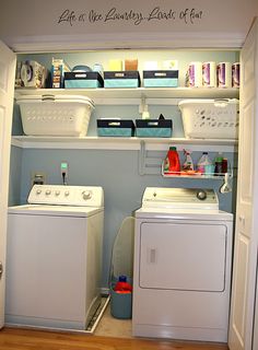 a washer and dryer sitting in a room next to each other on shelves