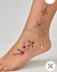 a woman's ankle tattoo with flowers and butterflies on it